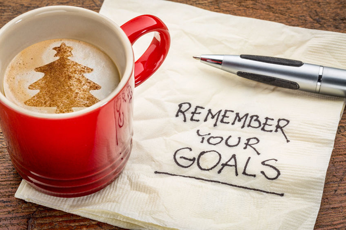 photo of coffee mug with coffee and napkin that reads: remember your goals